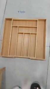 Expandable bamboo cutlery drawer organizer with multiple compartments for storing kitchen utensils, cutlery, forks, knives, spoons, and chopsticks