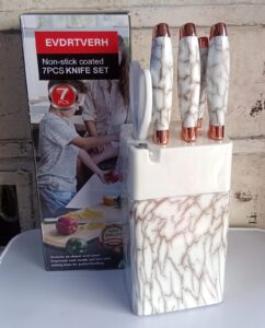 7-piece non-stick coated knife set with marble storage block and rose gold handles.